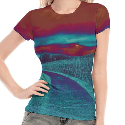 Woman wearing a colorful t-shirt with a scenic design on a white background