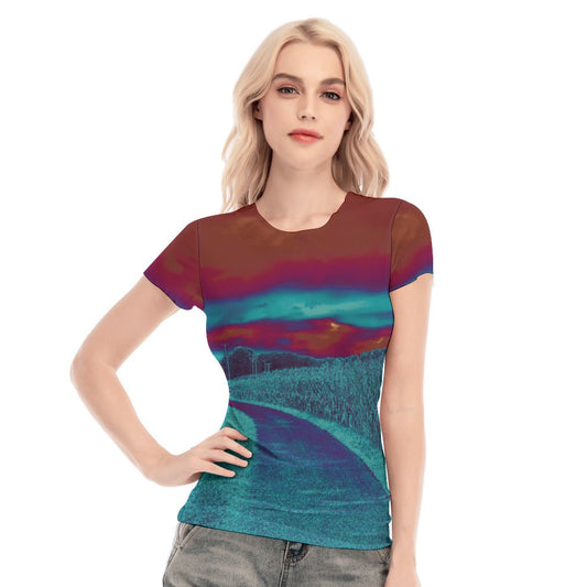 Woman wearing a colorful t-shirt with a scenic design on a white background