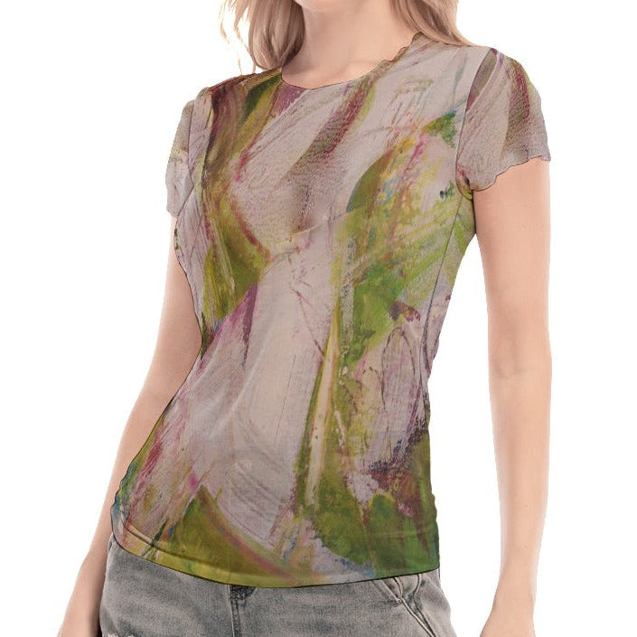 Woman wearing a sheer top with floral pattern and denim shorts on a white background