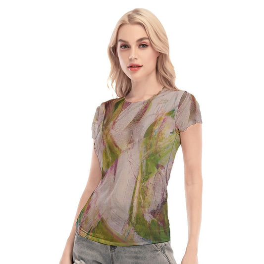 Woman wearing a sheer top with floral pattern and denim shorts on a white background